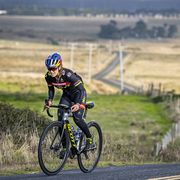 Kate Courtney rides a road bike uphill