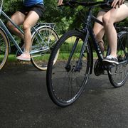 two cyclists learning how to ride bikes with flat pedals