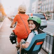 mother cycling home with her preschool child at sunset in tokyo