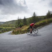 road cyclist climbing hairpin bends up steep road