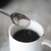 study sugar significantly raises risk of heart disease, stroke, sugar on coffee spoon in front of mug with black coffee